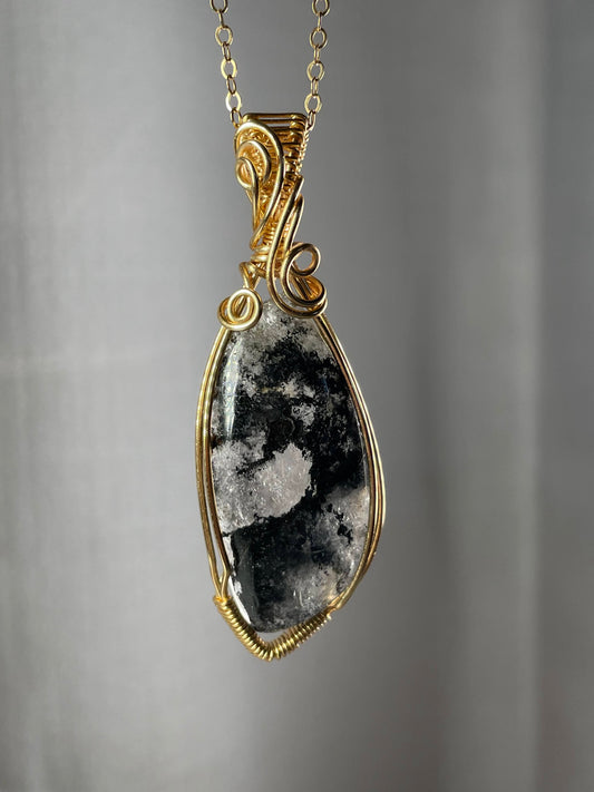 Black hematite in quartz pendant