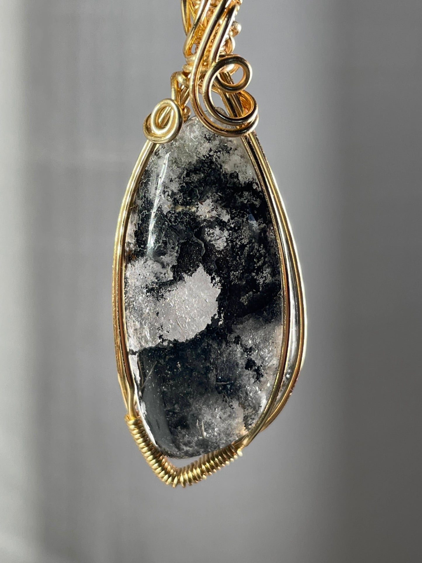 Black hematite in quartz pendant